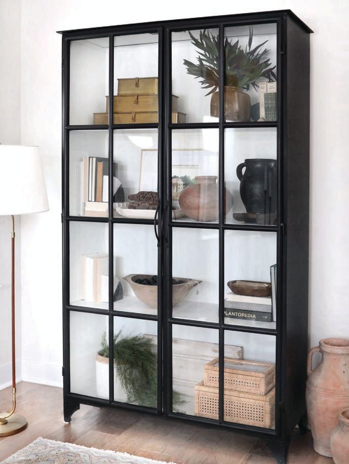 A metal glass door shelving unit from Four Hands. PHOTOGRAPHED BY RYAN SHAPIRO PHOTOGRAPHY